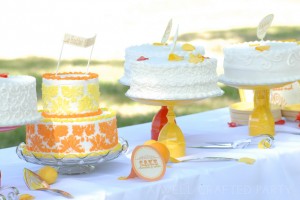 Cake Table Featuring 7 Different Flavored Cakes and DIY Cake Stands