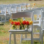 orange and yellow wedding flowers waiting to be put out for the party