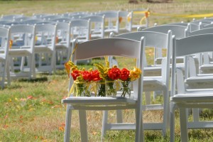 orange and yellow wedding flowers waiting to be put out for the party