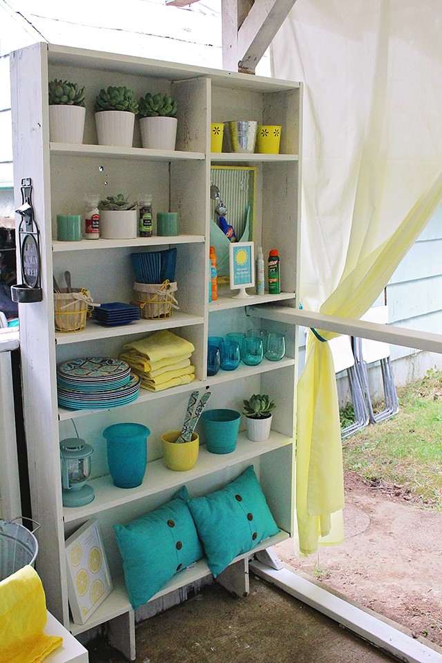 My porch bookshelf houses my many outdoor entertaining items in a neat and organized fashion. 