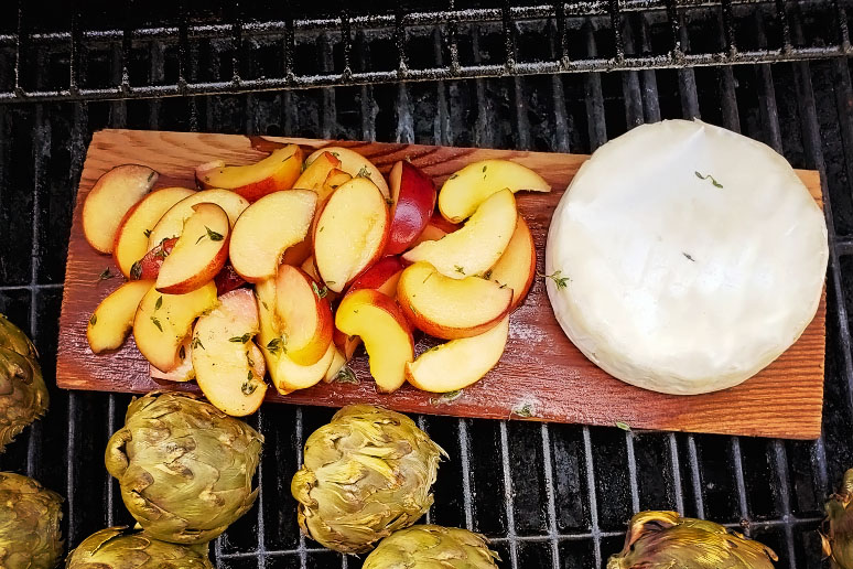 Grilling brie and peaches on a cedar plank prevents leaking.
