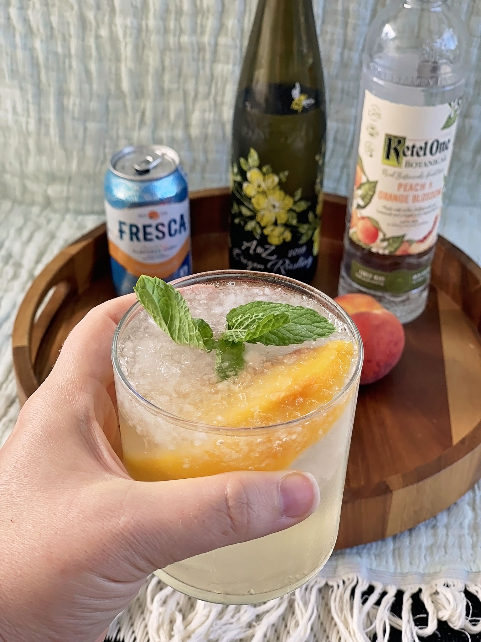 Sangria served with peach and mint featuring ingredients.