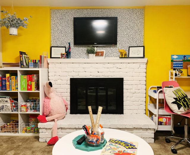 yellow painted playroom with desk area