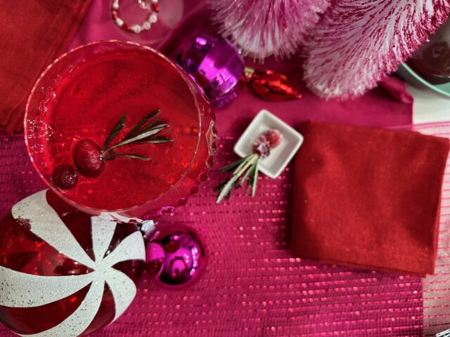 Holiday cocktail overhead shot with pink and red decor