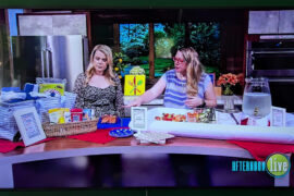 Photo of TV with shot of Hannah the host of Afternoon Live on KATU with Jenni Bost of A Well Crafted Party behind a party set up for a summer pool party