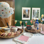party set up with ice cream sandwich bar, ice cream sundae bar, and ice cream decor items