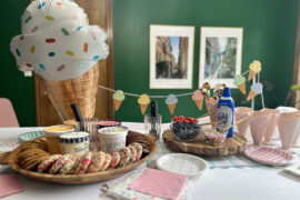 party set up with ice cream sandwich bar, ice cream sundae bar, and ice cream decor items